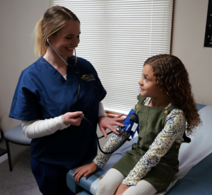 East Ohio College nursing student making connection with young patient.